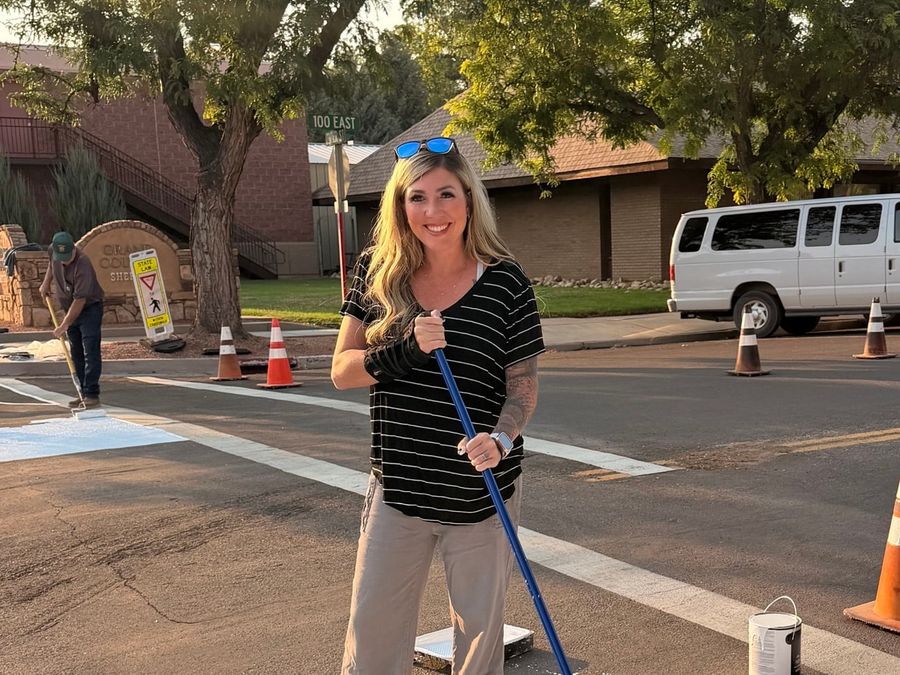 Shalee Holland volunteering on a community painting project in downtown Moab